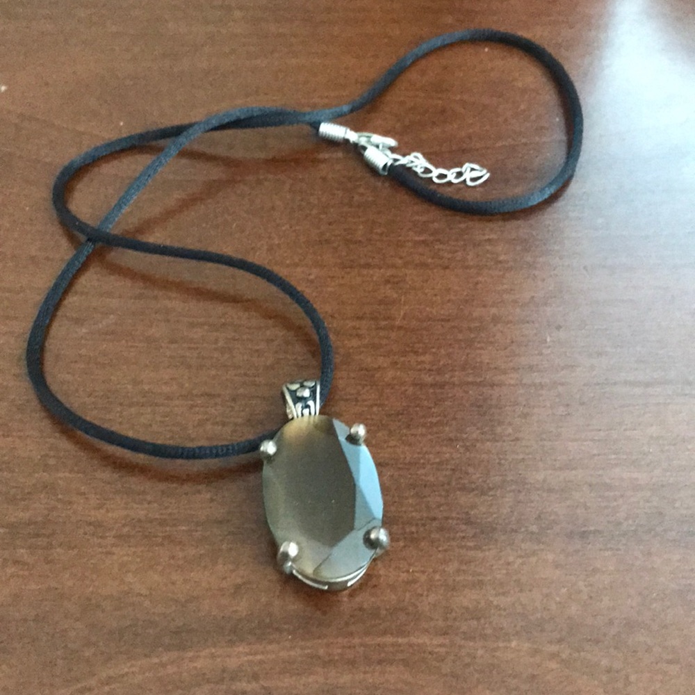 Brown glass pendant on a black fabric cord